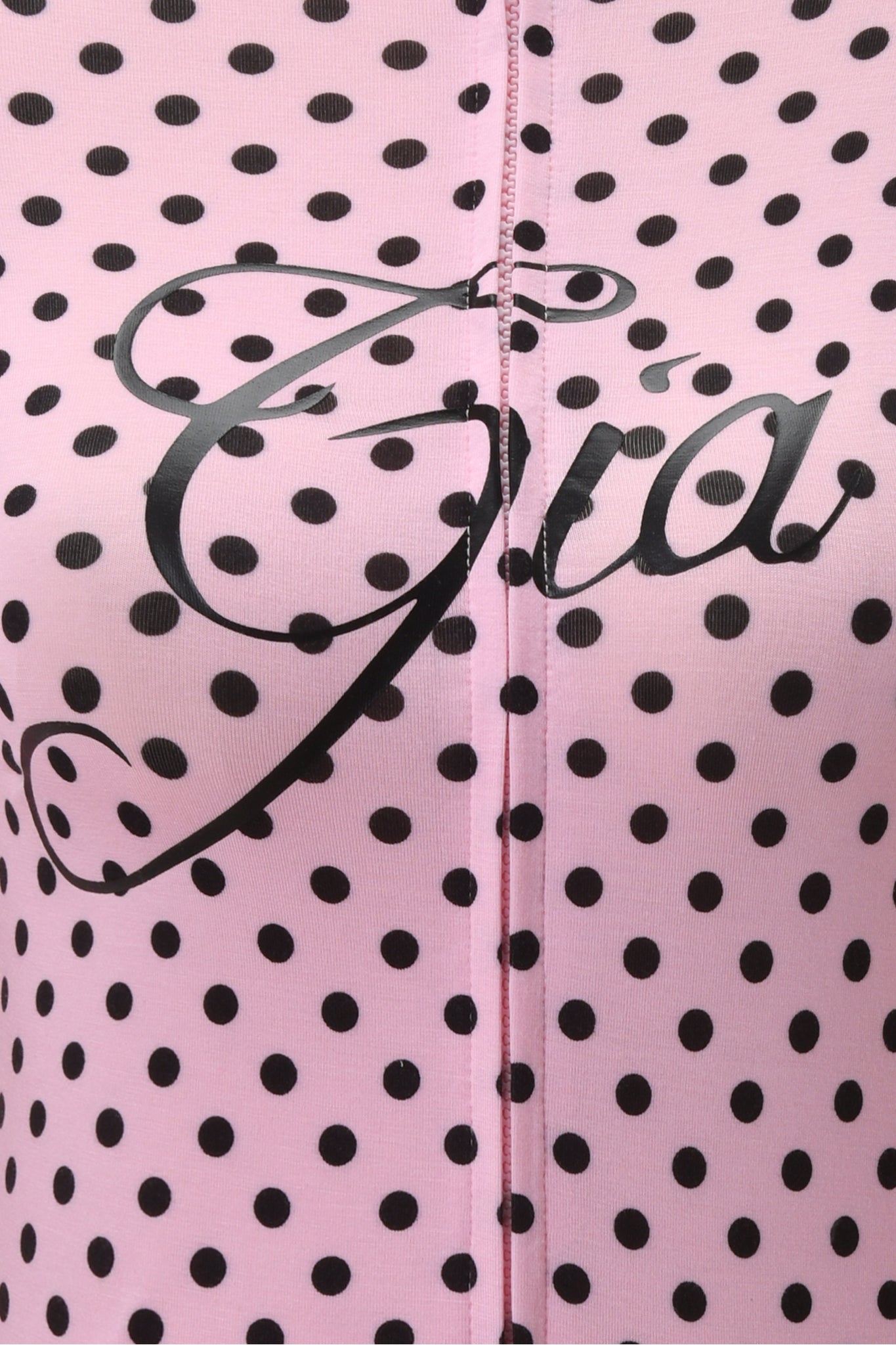 Close-up of the BLARE HOODIE - PINK POLKA DOT by I.AM.GIA, featuring pink and black polka dot bamboo fabric, black cursive "Gia" text, and a vertical central seam.