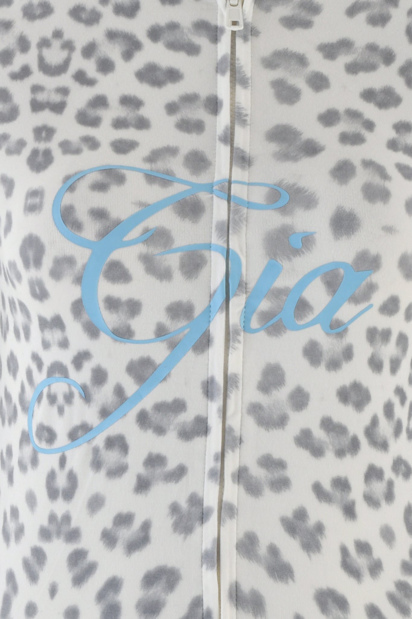 Close-up of the BLARE HOODIE - SNOW LEOPARD : WINTER WILD CARD featuring a gray snow leopard print fabric with a central zipper. The brand name "I.AM.GIA" is elegantly scripted in bold blue across the material, adding an extra touch of style.