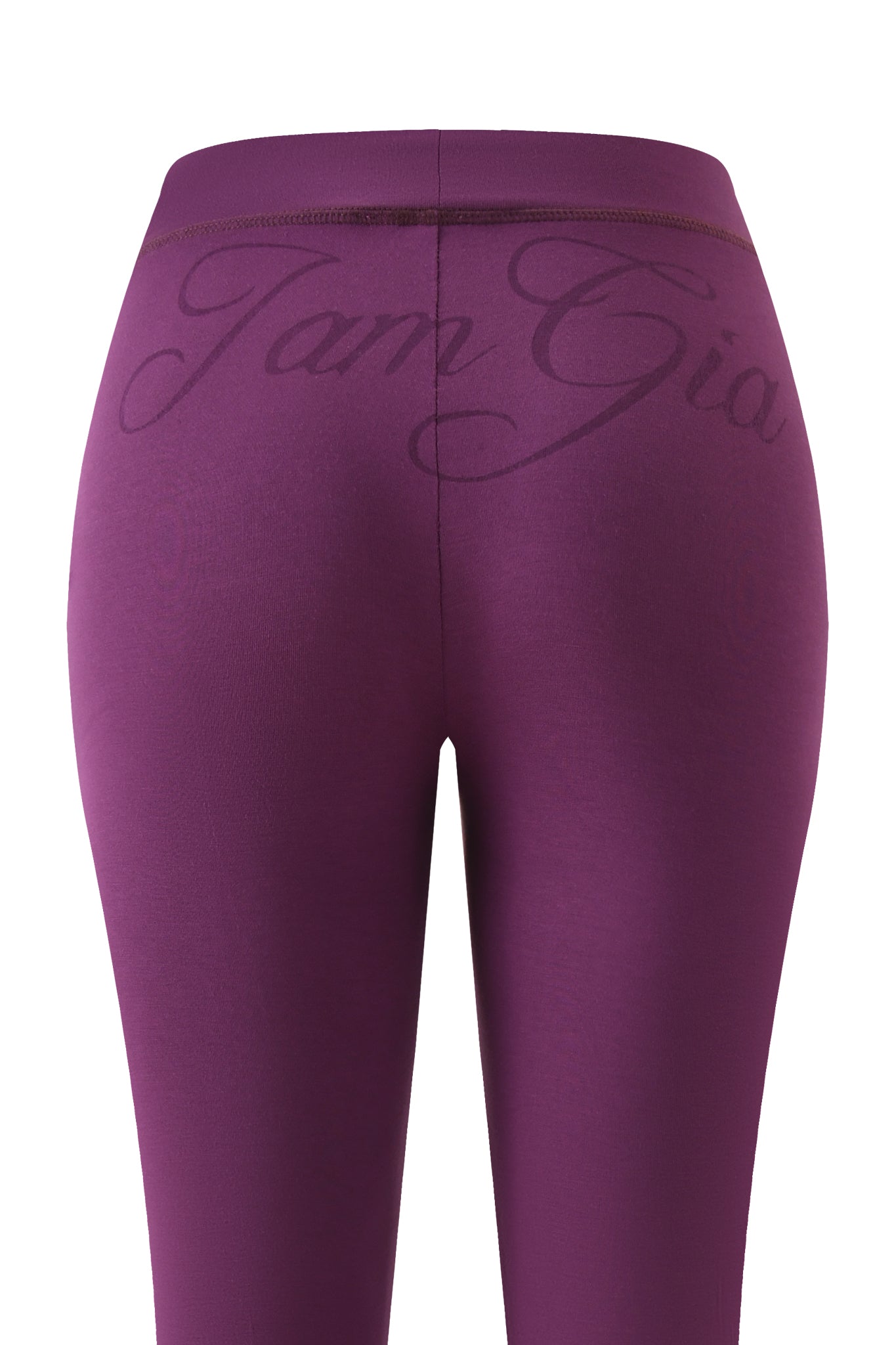 Back view of BLARE TRACKPANT - PLUM by I.AM.GIA, featuring a low-rise waist with "I.AM.GIA" in cursive across the waistband and a sleek bodycon fit.