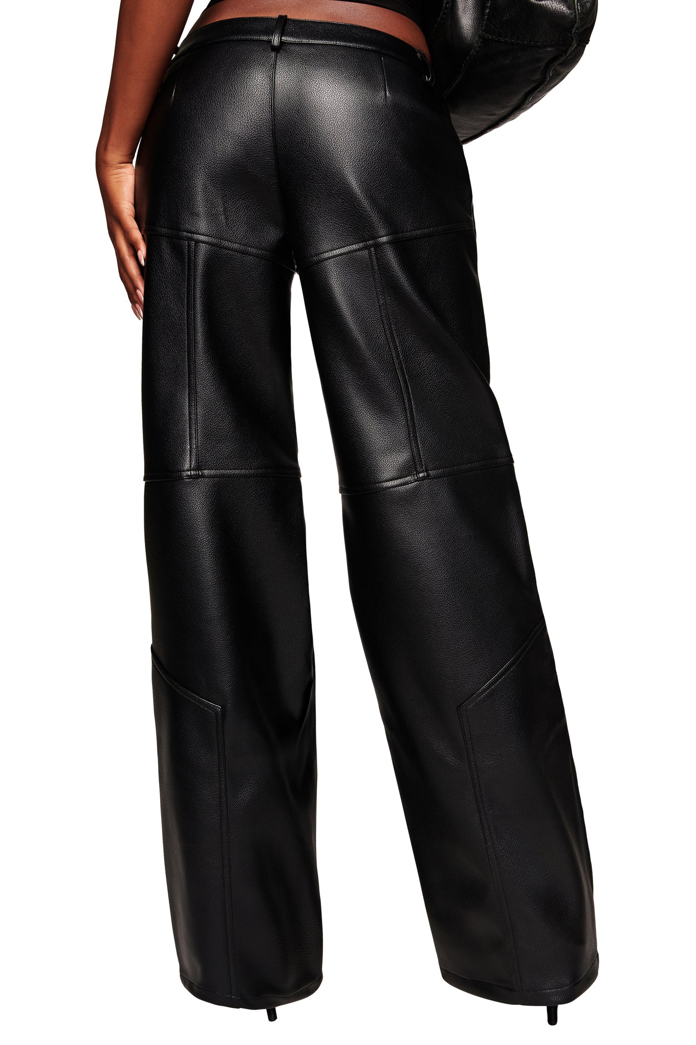 Model shown from the back in I.AM.GIA’s KRISTIE PANT - BLACK, a high-waisted, wide-leg faux leather style with visible seam detailing and a smooth, slightly glossy finish, set against a white background.