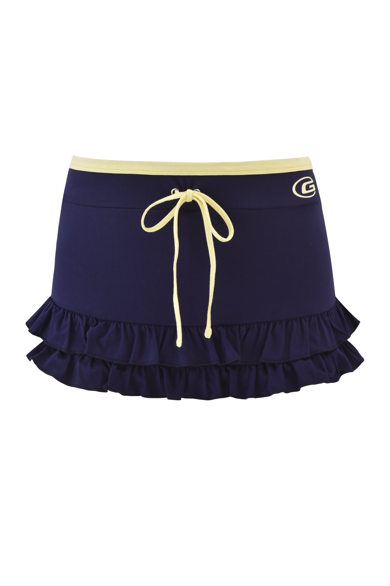 The MICHELLE SKORT - NAVY by I.AM.GIA is a navy blue low-rise mini skort featuring a yellow drawstring waist, yellow top trim, stylish ruffle hem, and a small "G" logo on the left near the waistband.
