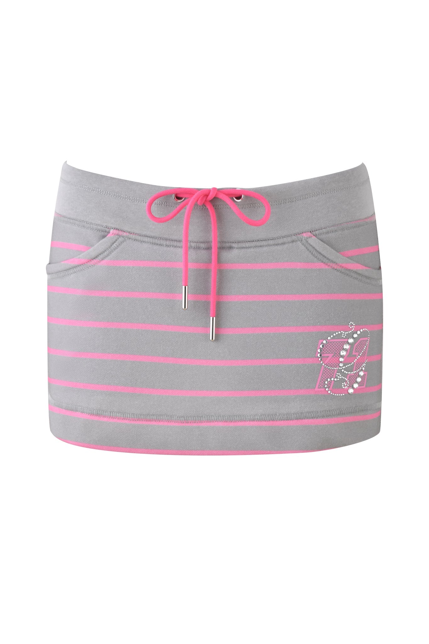 The EZORA SKORT 2.0 - GREY : PINK by I.AM.GIA is a gray low-rise mini skort with pink horizontal stripes and an adjustable pink drawstring. It includes two front pockets and features a decorative custom GIA logo with rhinestones on the lower left side.
