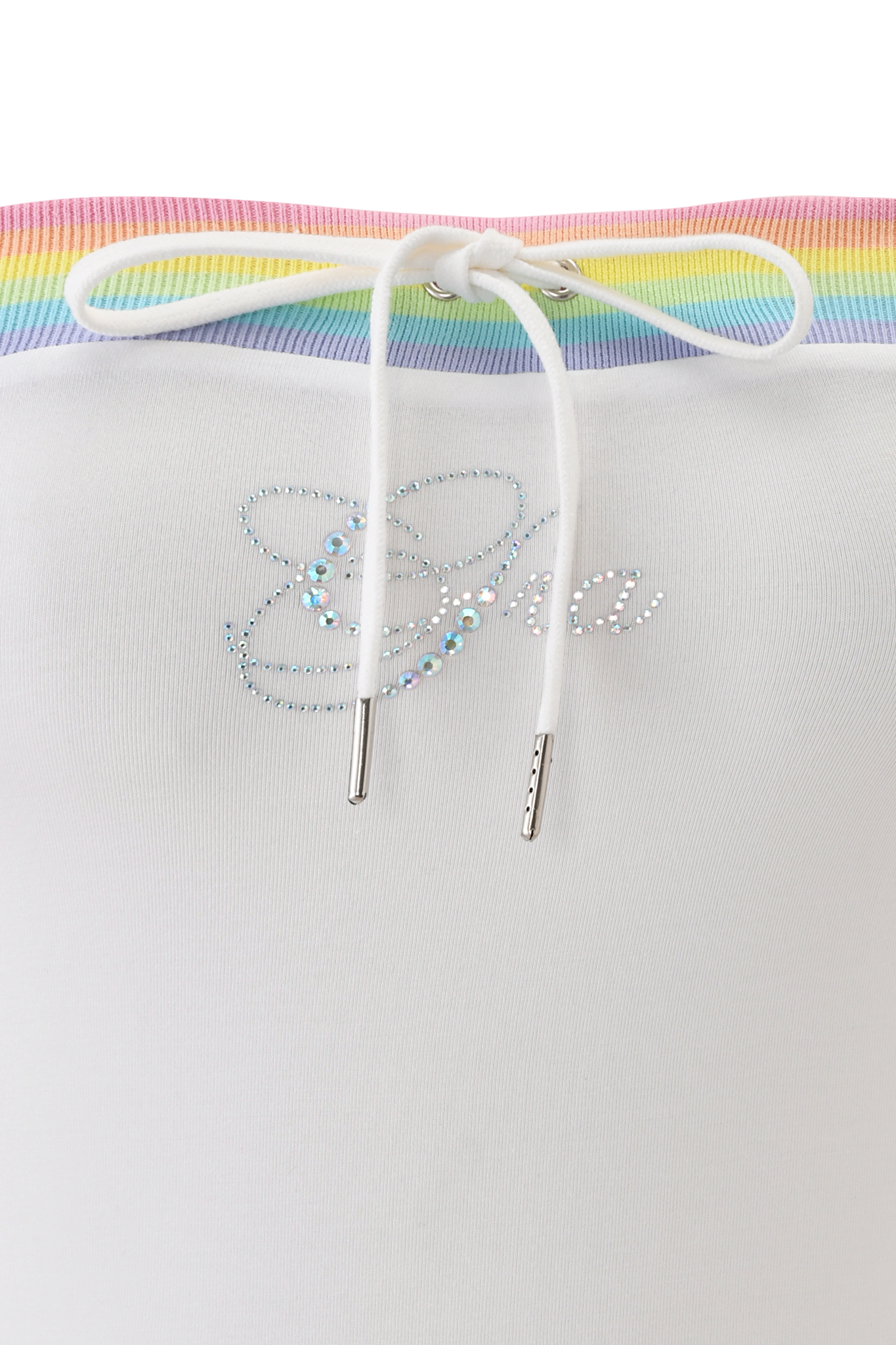 Close-up of the NIJI BOOB TUBE - WHITE by I.AM.GIA, a white bamboo jersey top with rainbow-striped trim, white drawstring, and iridescent diamante butterfly and cursive embellishments. Pink gradient background at the top.