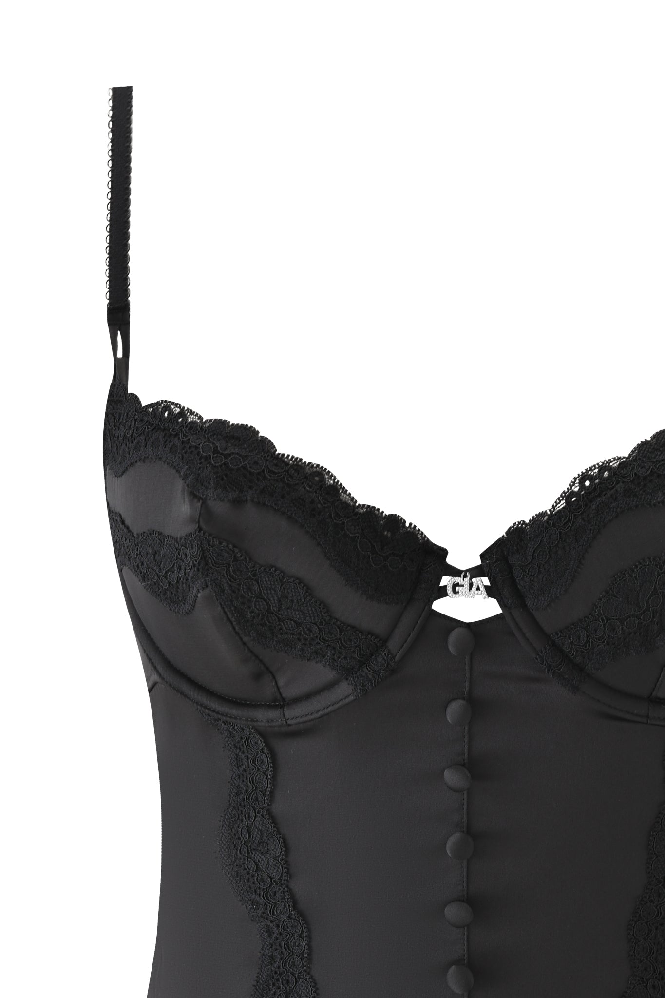 The ASHLING BUSTIER - BLACK by I.AM.GIA features adjustable satin straps, lace-trim detailing, decorative front buttons, underwire cups, and a small silver emblem at the center.