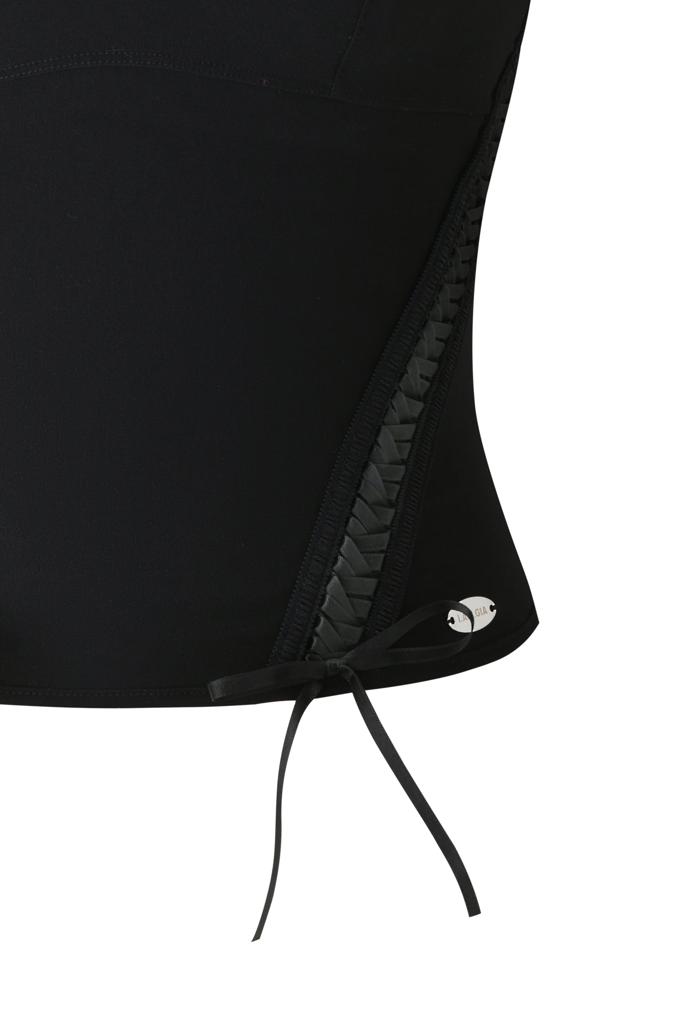 Close-up of the I.AM.GIA SAMIRA BUSTIER in black, showcasing ruched sides, braided ribbon tie at the bottom, and a metallic logo charm near the hem.