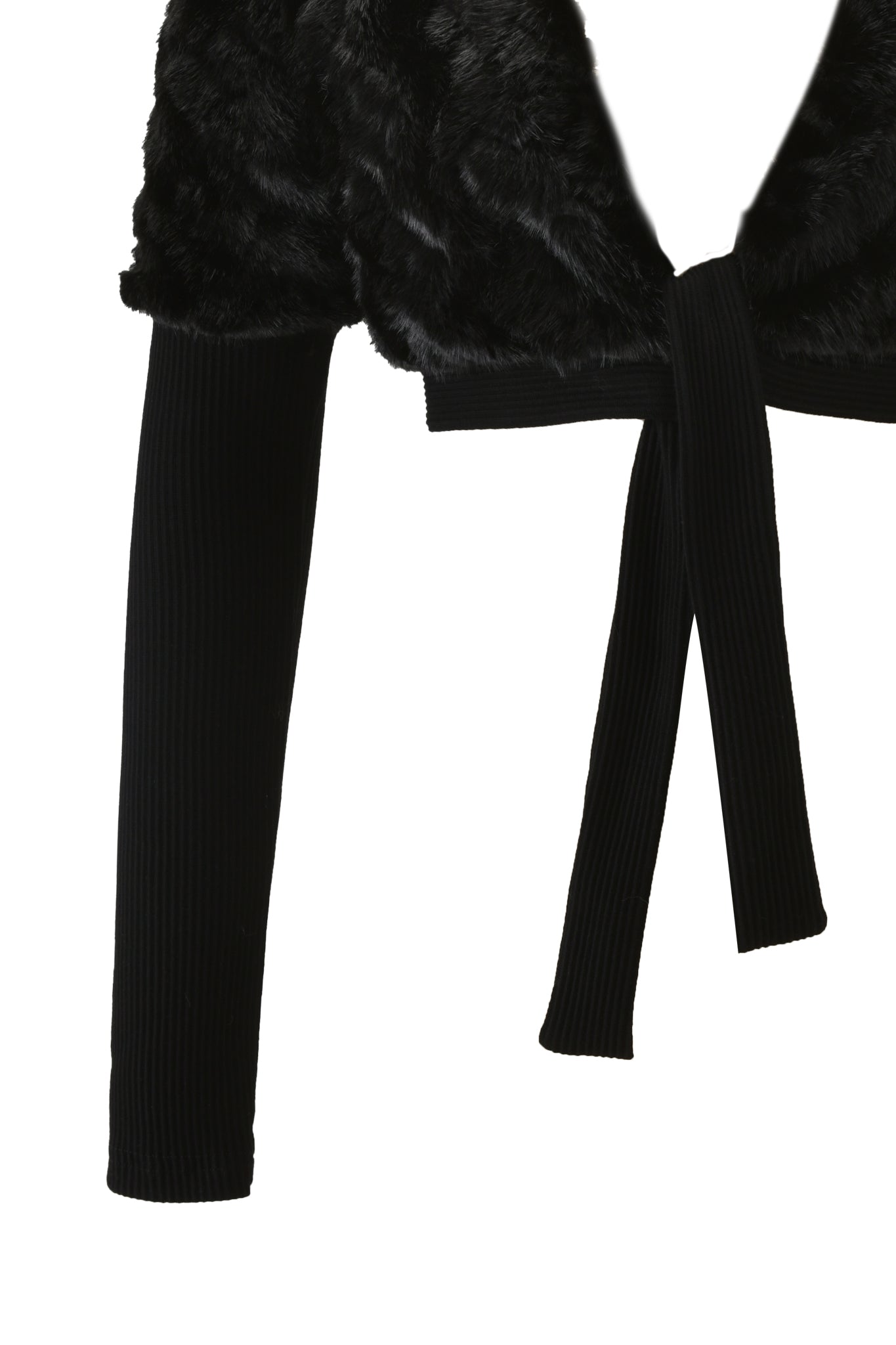 The RUBY BOLERO - BLACK by I.AM.GIA is shown close up, highlighting its textured faux fur upper, rib knit sleeves, and front tie detail against a white background.