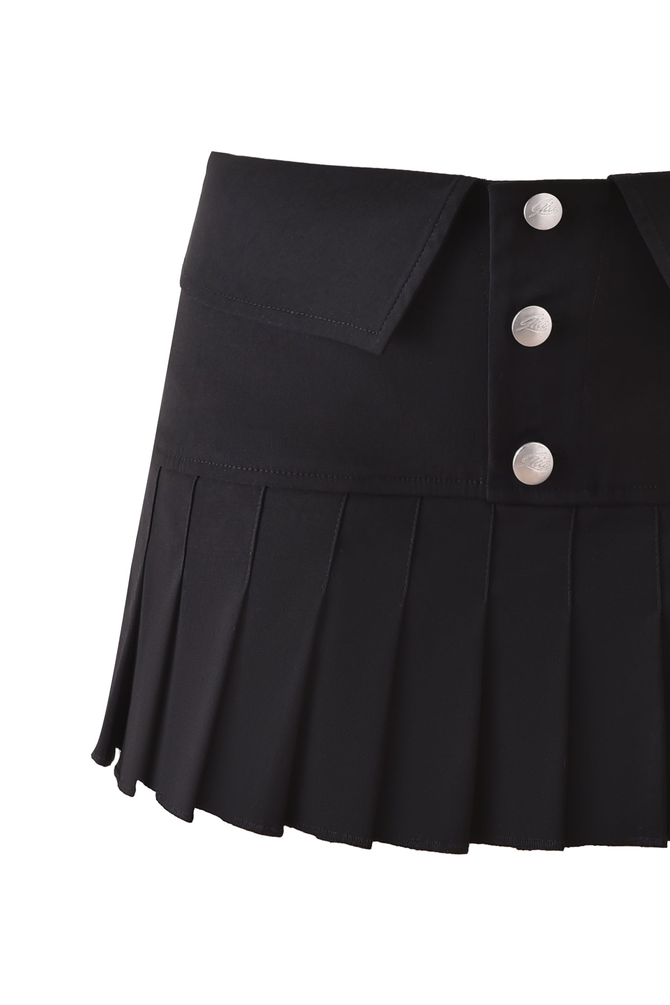 The BLAKE MINI SKORT - BLACK by I.AM.GIA features black pleats, silver buttons, and a flap detail at the mid-rise waist, shown against a white background.