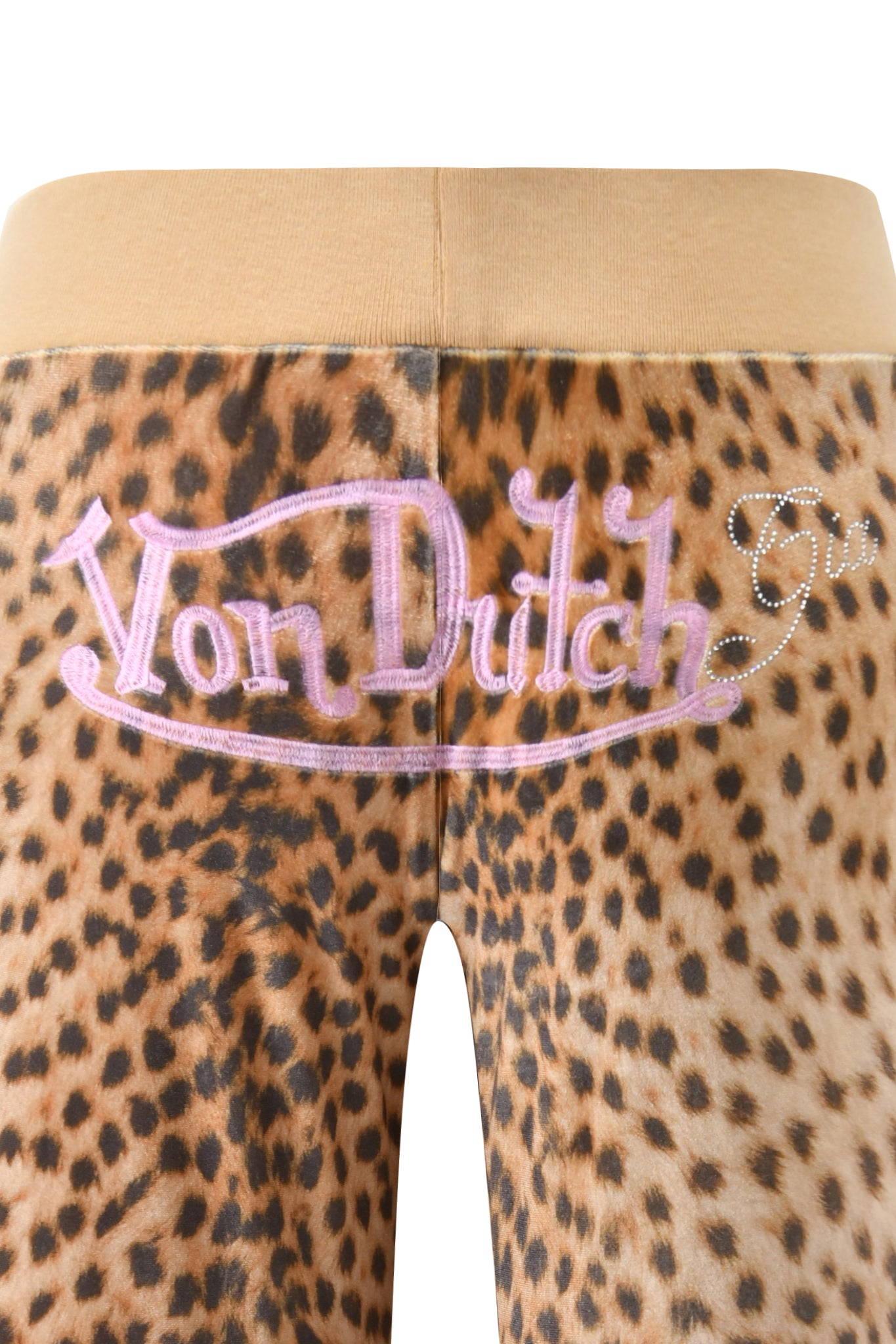 Close-up of the I.AM.GIA X VON DUTCH KAMERON VELOUR TRACKPANT in leopard print with a tan elastic waistband and "Von Dutch" in pink embroidery and rhinestones on the back—a bold, trendy statement from I.AM.GIA.