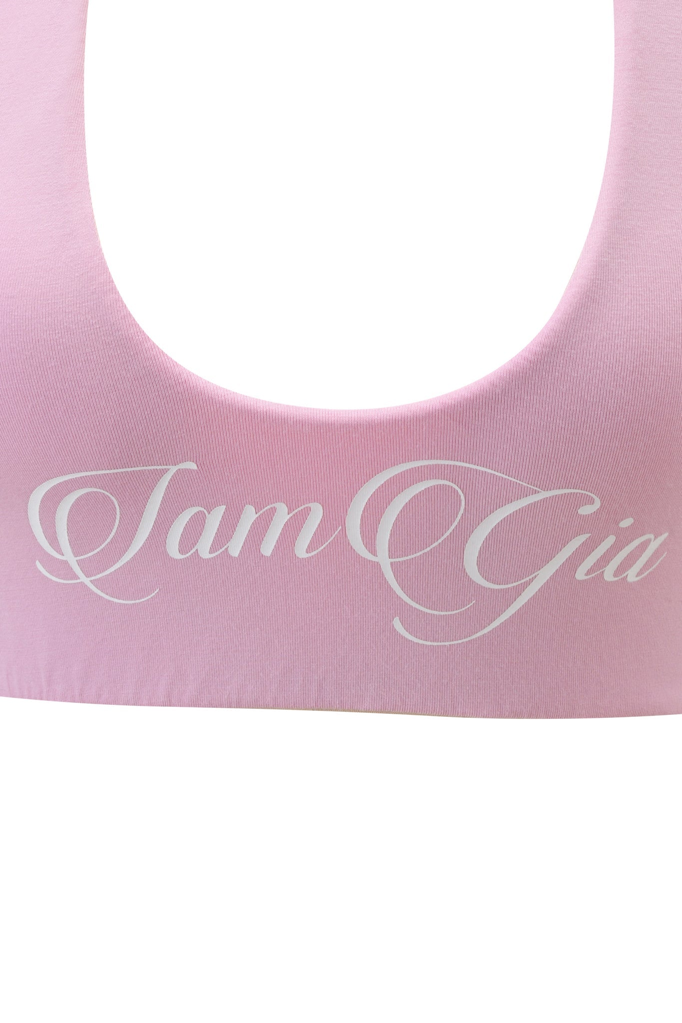 A close-up of the I.AM.GIA BLARE HALTER CROP TOP in baby pink and white, featuring "I.AM.GIA" printed in elegant white script across the chest.