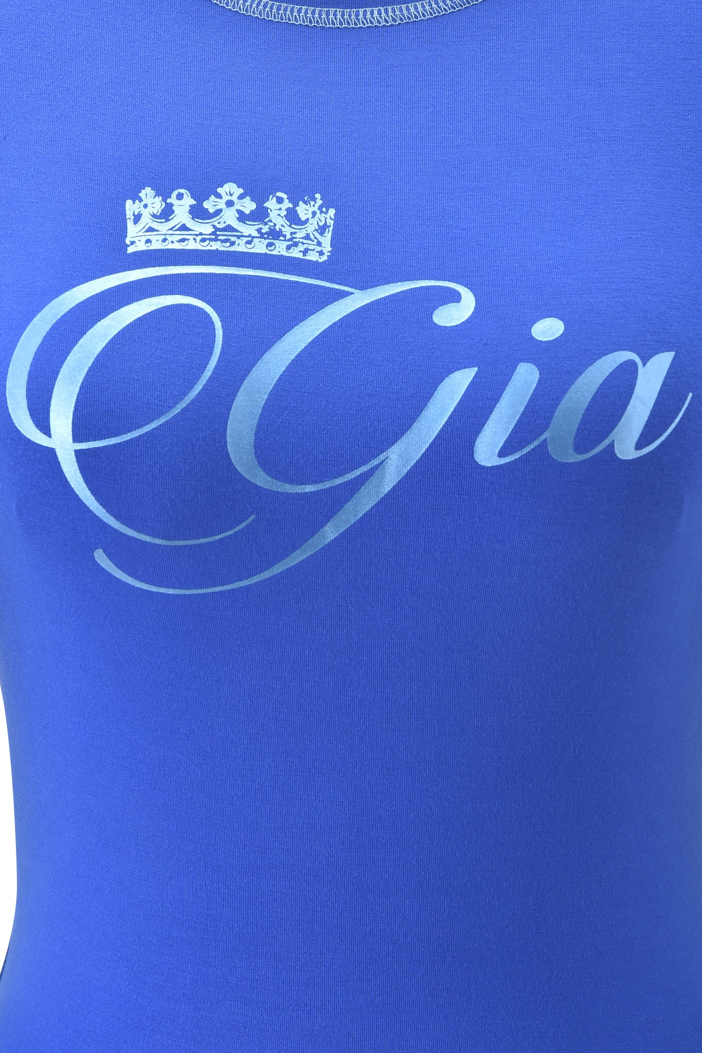 A close-up of the I.AM.GIA BLARE FORM TEE - COBALT FOIL, featuring "Gia" in elegant script with a crown above the "G," all on soft bamboo fabric for exceptional comfort.