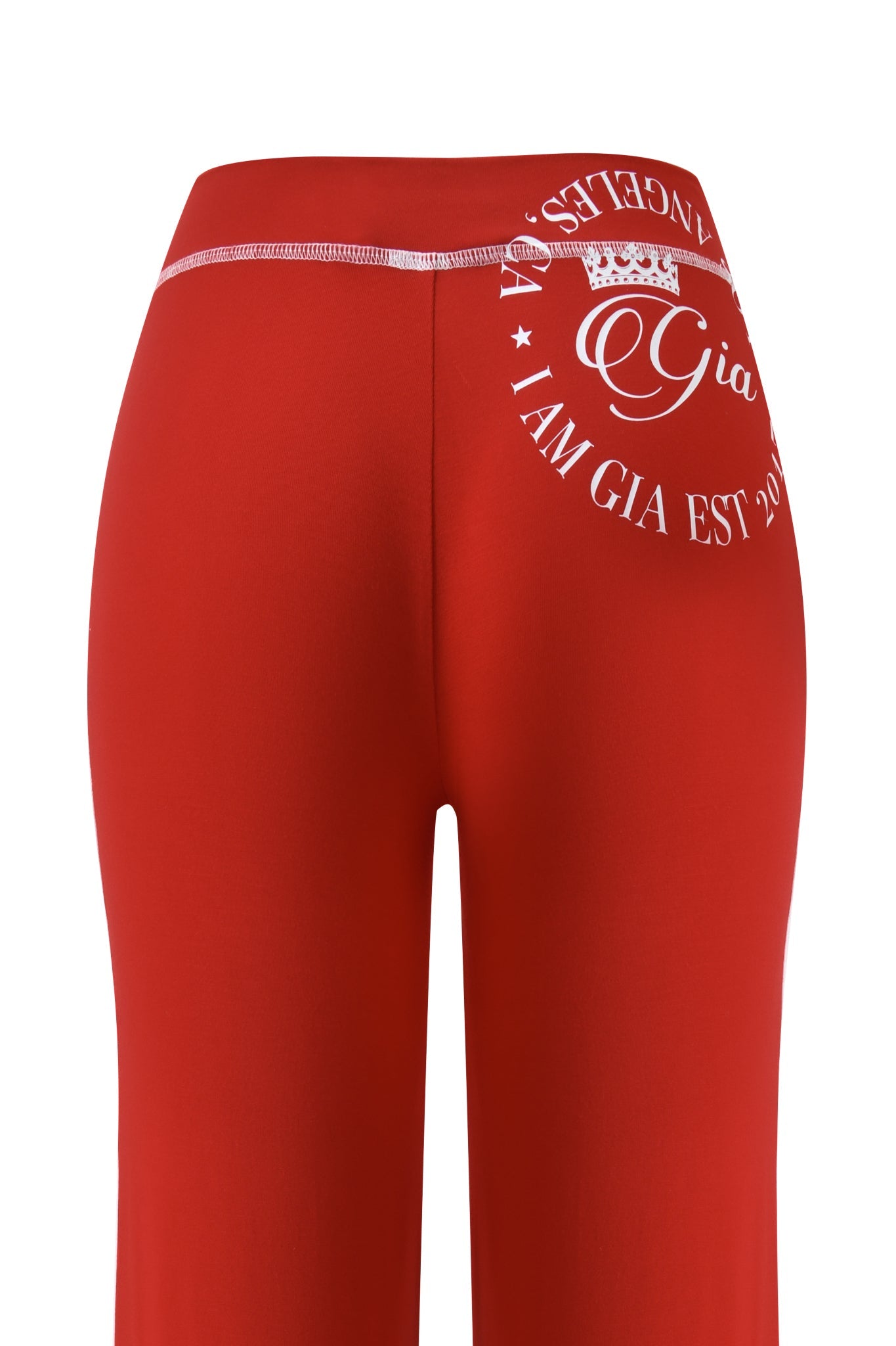 The I.AM.GIA BLARE BAMBOO PANELLED TRACKPANT in red features a straight leg silhouette and a circular white graphic with text and a crown on the right hip, shown from the back.