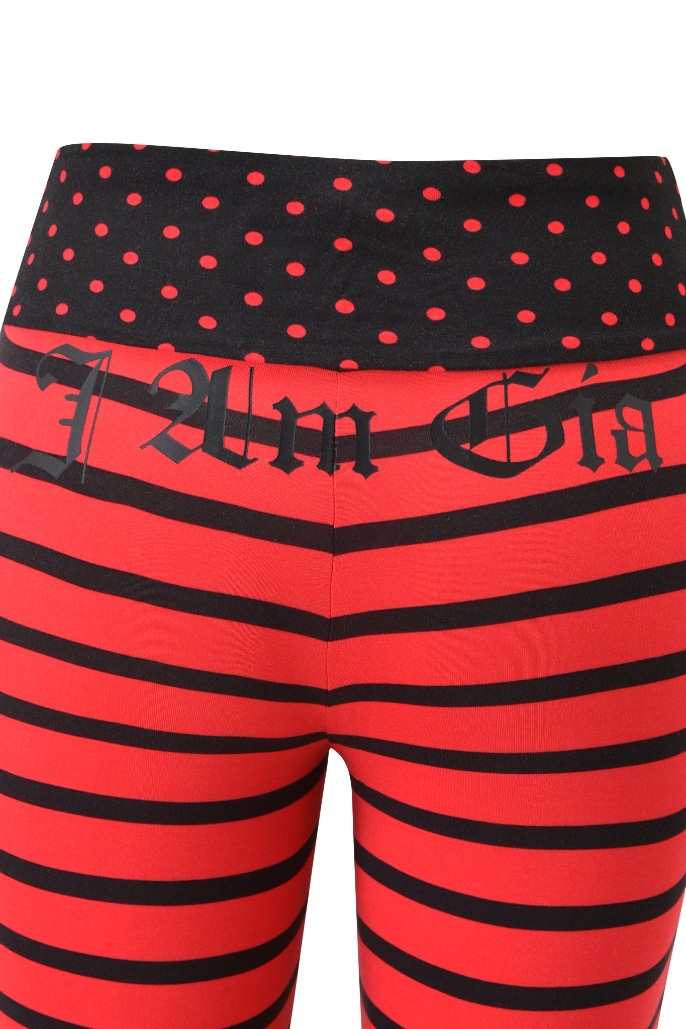 The BLARE FOLDOVER TRACKPANT by I.AM.GIA features red and black stripes, a foldover waistband with red polka dots, and "I Am Ga" in Gothic-style text across the top front.