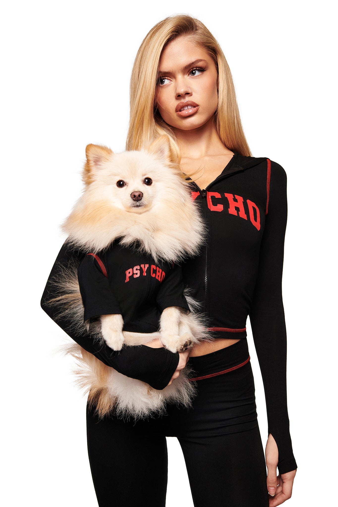 A woman and her dog wear matching outfits, with the pup looking adorable in the I.AM.GIA BLARE BEST FRIEND DOG HOODIE - BLACK PSYCHO.