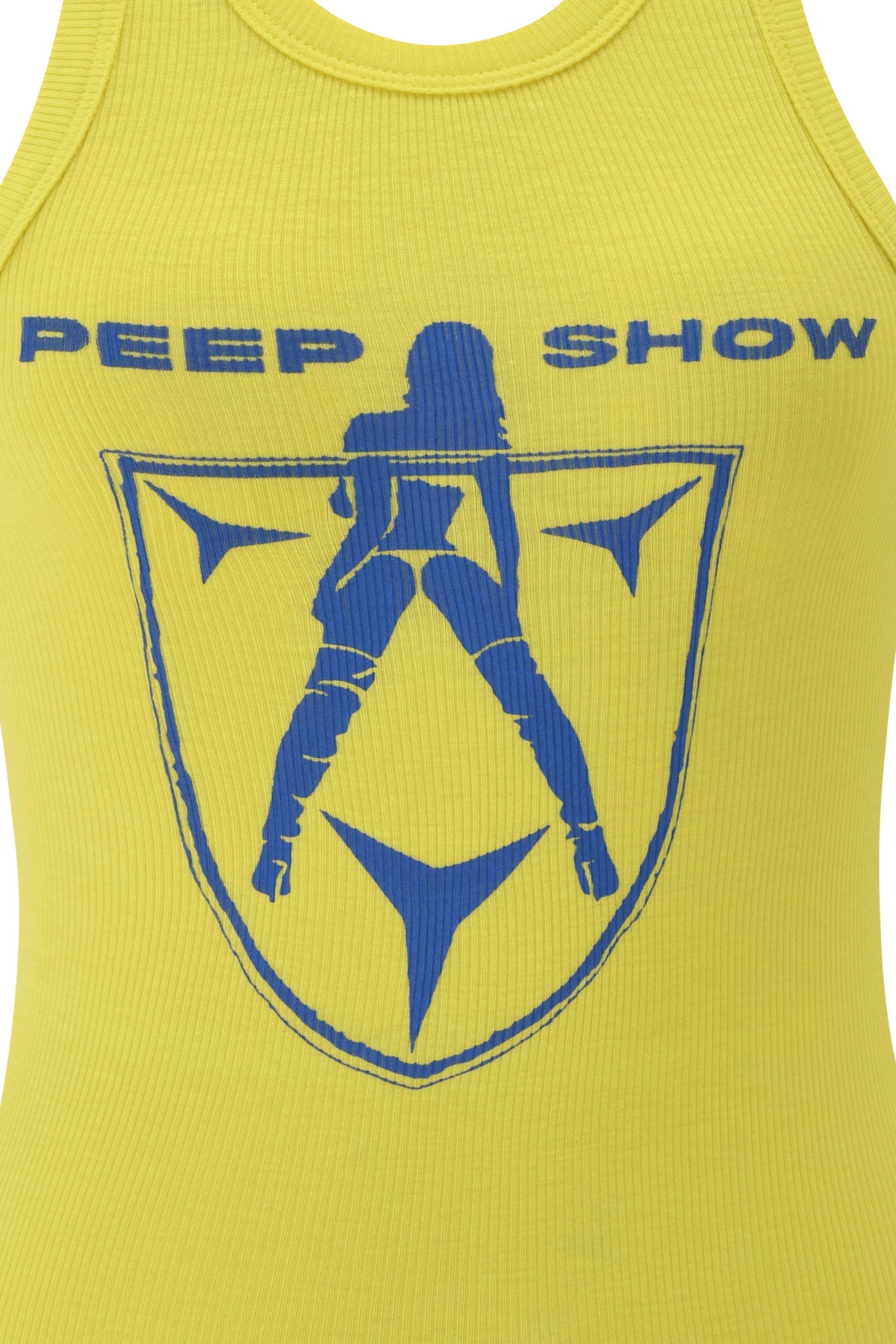 The I.AM.GIA PENELOPE TANK - BLUE PEEP SHOW is a ribbed racer tank with a blue graphic of a silhouetted woman in a shield and bold "PEEP SHOW" text, adding playful edge to your style.