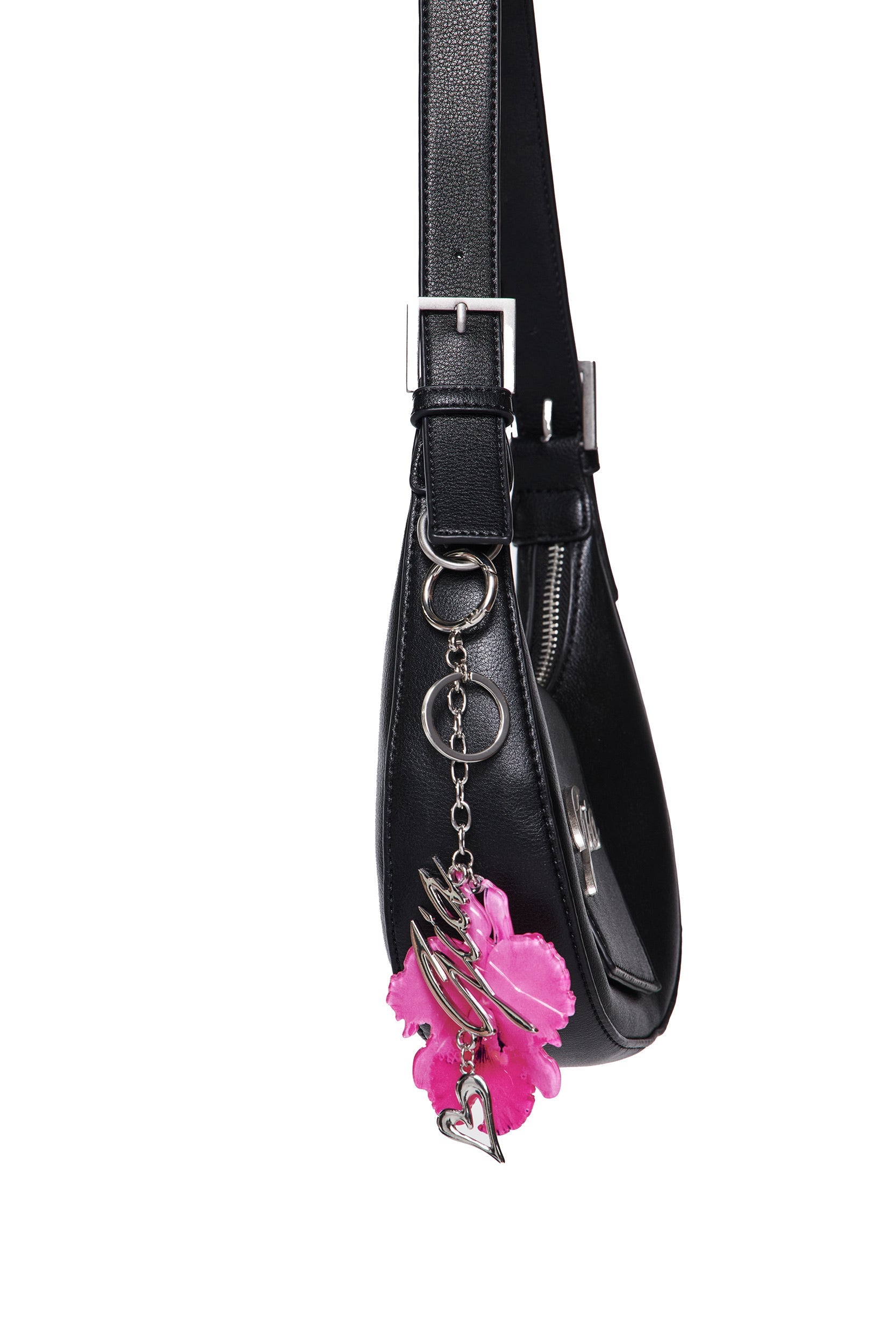 A black handbag featuring a neon pink ORCHID KEYCHAIN with silver swirls, a heart charm, and an I.AM.GIA metal logo hanging from a metal ring on the side.