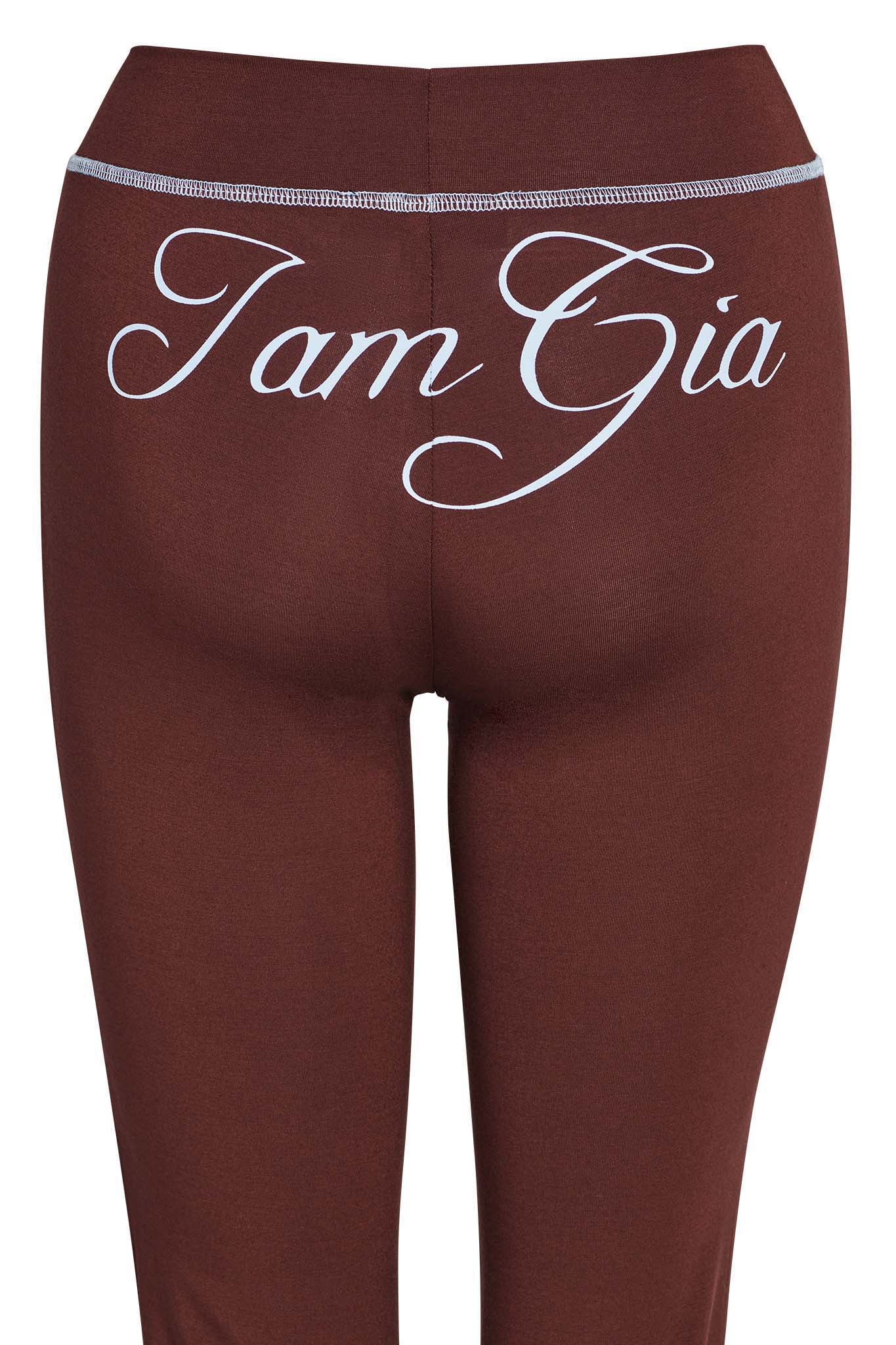 A close-up image of the back of BLARE TRACKPANT - BROWN, featuring "I.AM.GIA" written across the waistband in stylish white cursive lettering.