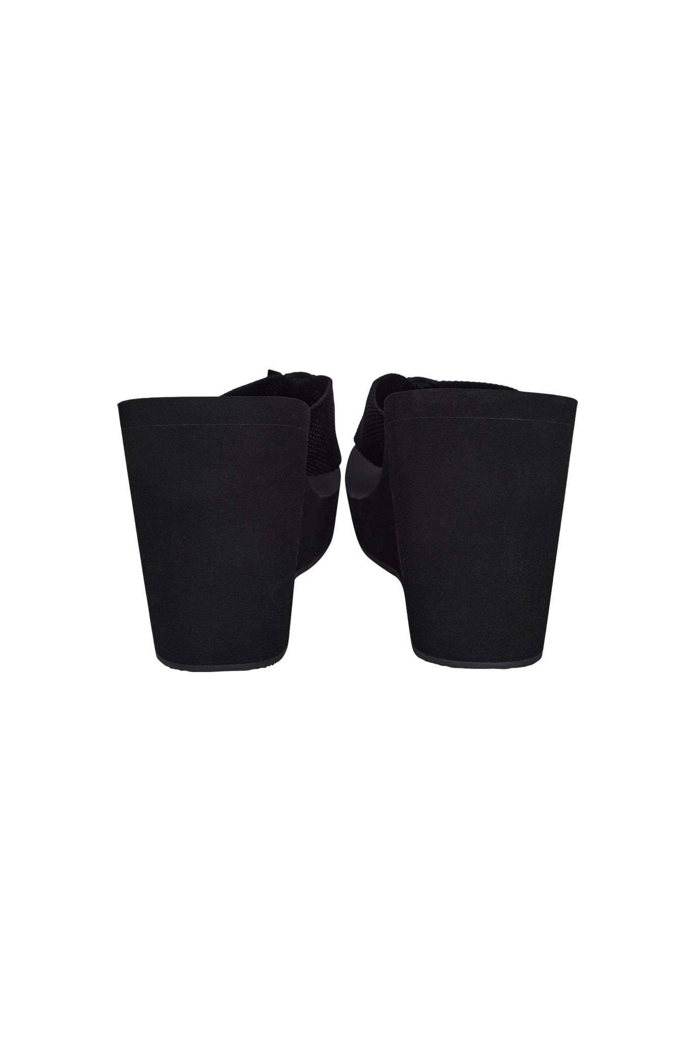 Rear view of a pair of SHELBY FLIP FLOP - BLACK wedge sandals with thick, solid heels from I.AM.GIA. The shoes feature a closed back design and the uppers seem to be made of a soft material. They are displayed on a plain white background.