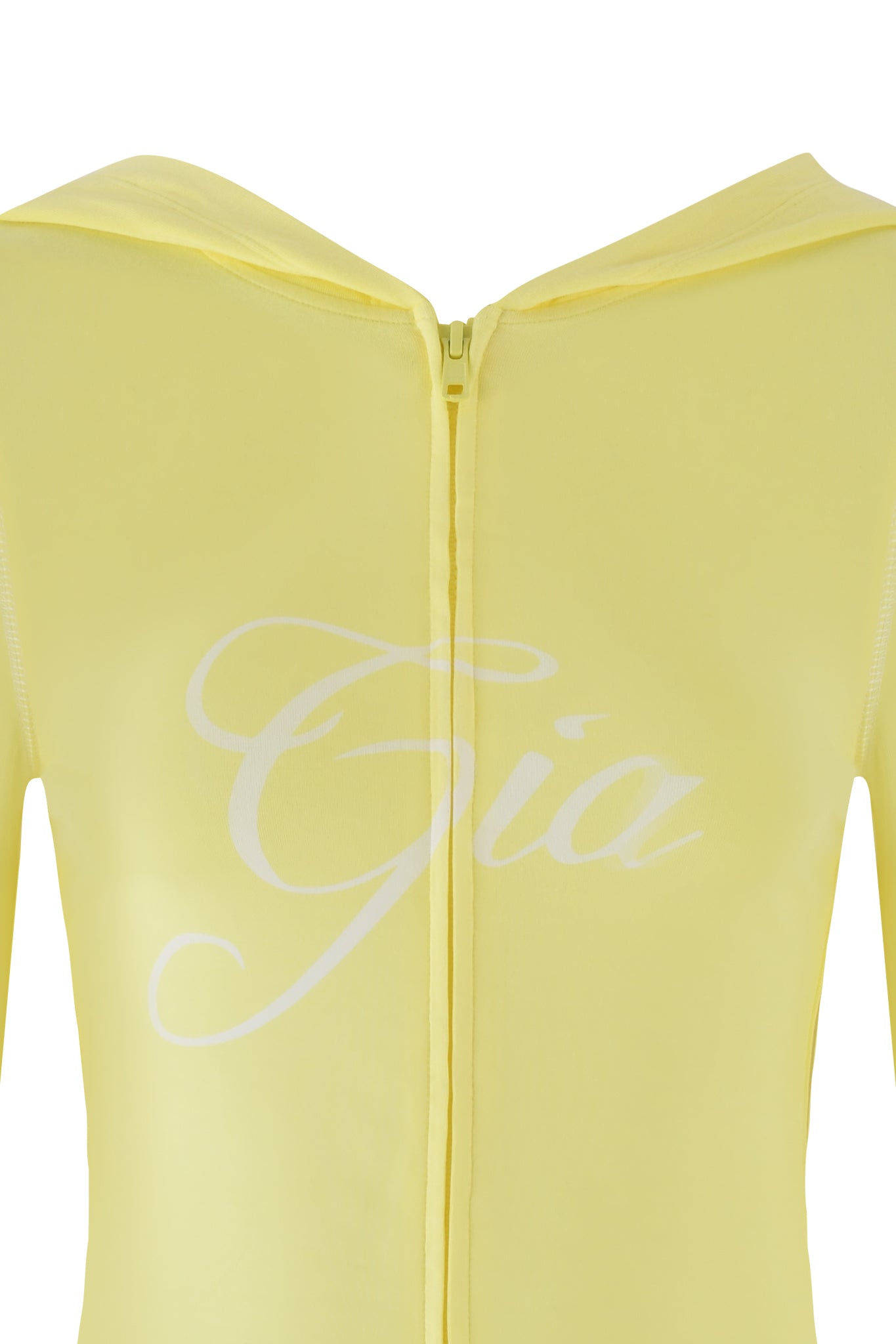 A close-up of a pale yellow Blare Hoodie from I.AM.GIA, featuring a front zipper and "Gia" in elegant white script on the chest. The fabric is smooth and lightweight, suggesting a casual, comfortable fit.