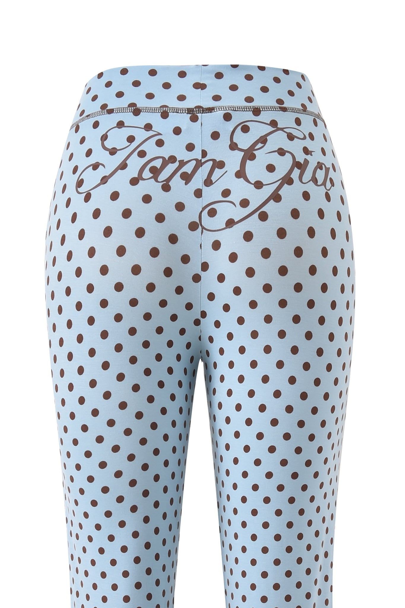 Back view of the I.AM.GIA BLARE TRACKPANT - BLUE POLKA DOT, featuring brown polka dots and "Tom Girl" script across the low-rise waist.