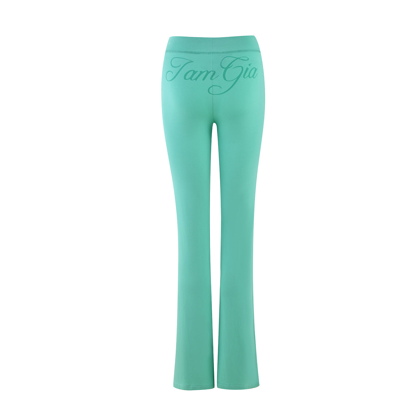 I.AM.GIA presents the BLARE TRACKPANT in turquoise-teal. These mint green, high-waisted stretch bamboo pants feature flared legs and "Tam Gia" in cursive on the back waistband, vividly contrasted against a plain white background.