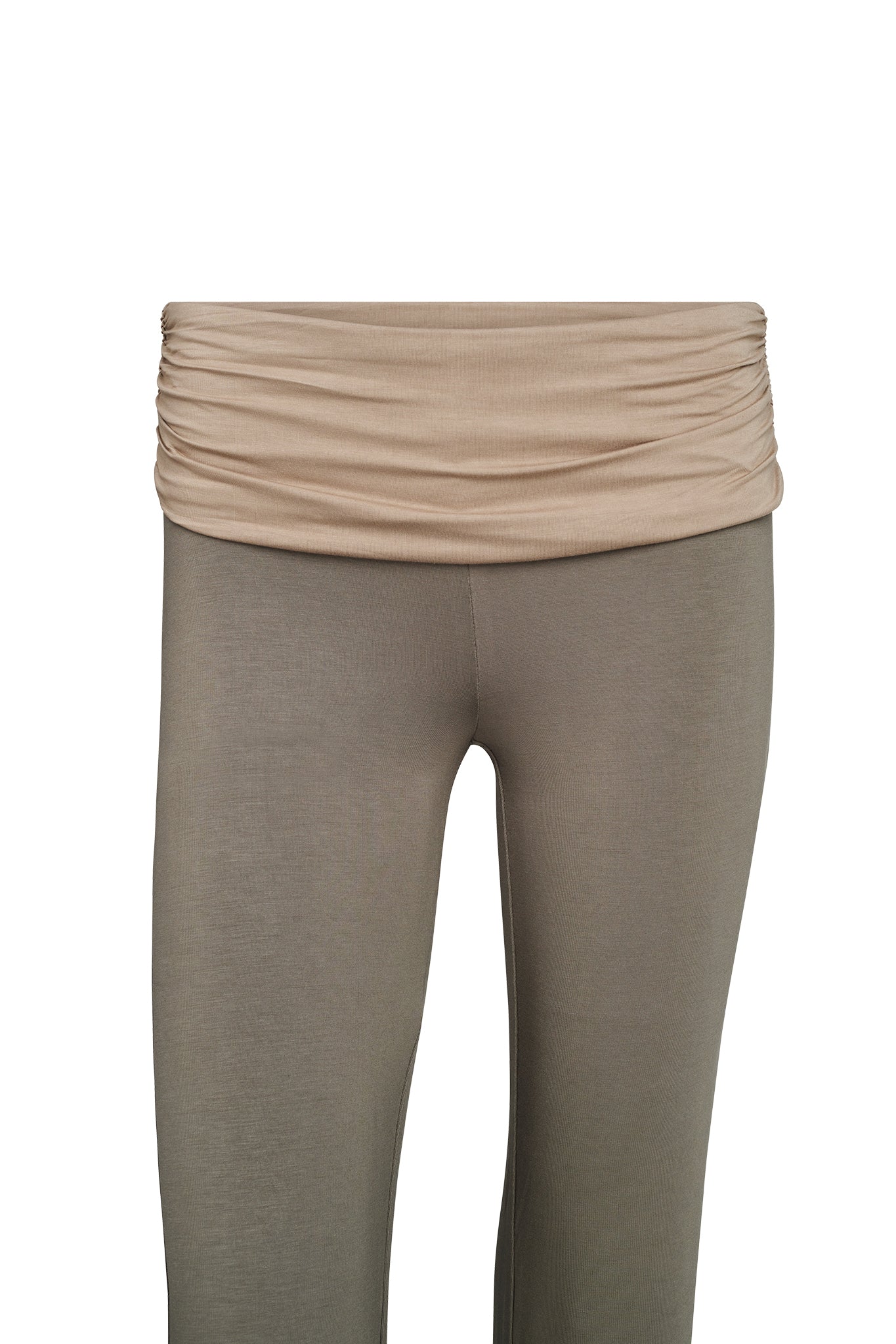 A close-up image of a pair of high-waisted, green-colored leggings named JANNIS PANT by I.AM.GIA with a ruched waistband. The leggings are displayed against a plain white background, showcasing the section from the waist to mid-thigh. These stylish yoga pants offer comfort and functionality for any activity.