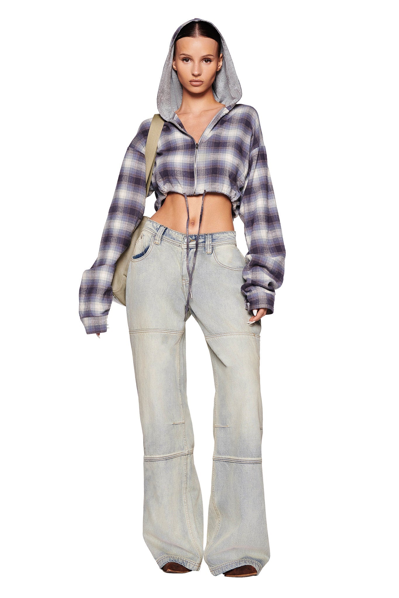 A person in the TIFF JACKET - BLUE by I.AM.GIA paired with high-waisted, wide-leg jeans stands against a white background. They carry a beige bag over their shoulder. The outfit has a casual, trendy style.