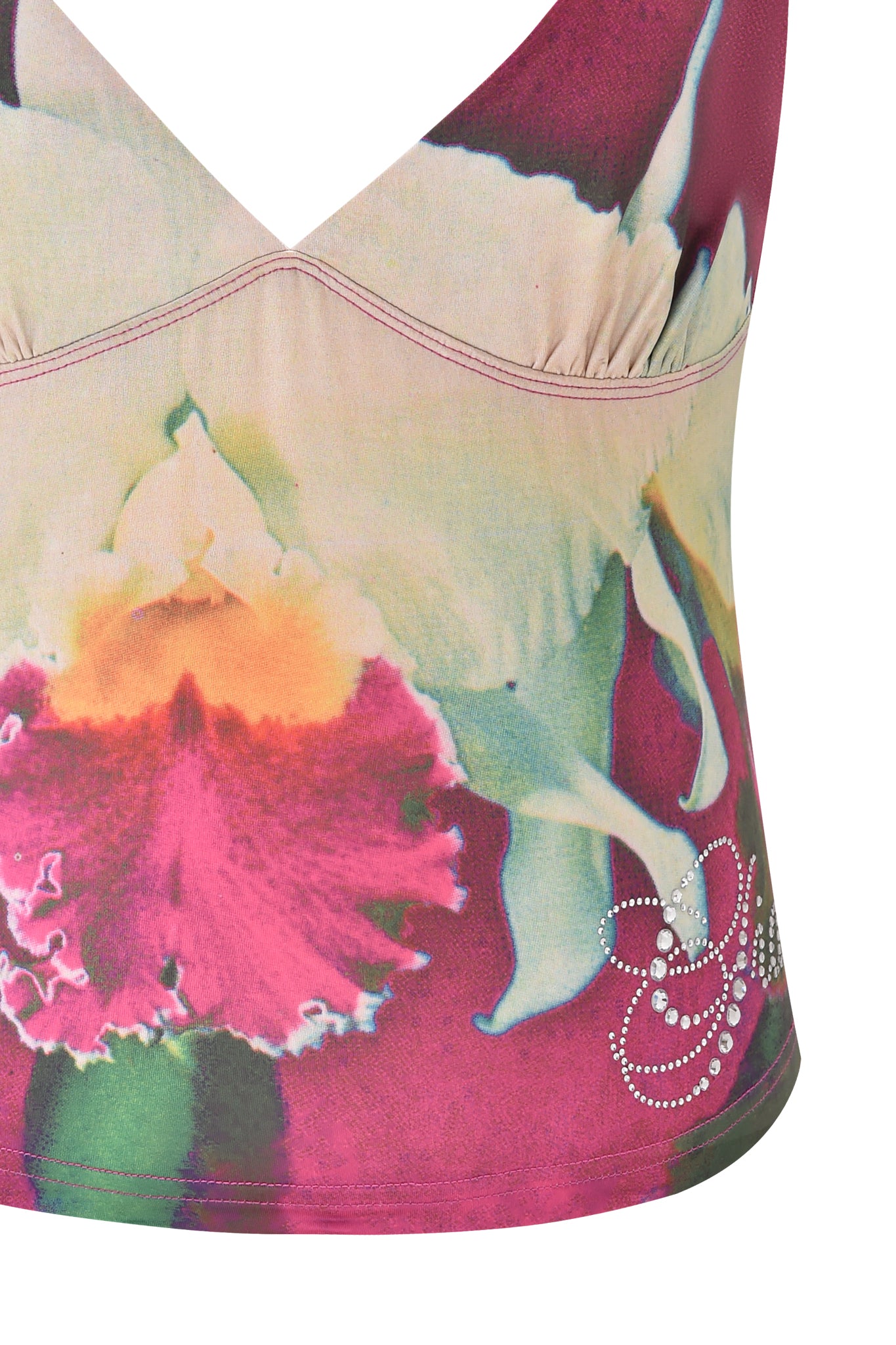 A close-up of the I.AM.GIA ODETTA TOP - FUCHSIA shows a bodycon silhouette with vibrant pink, white, and green floral prints and rhinestone detailing near the hem.