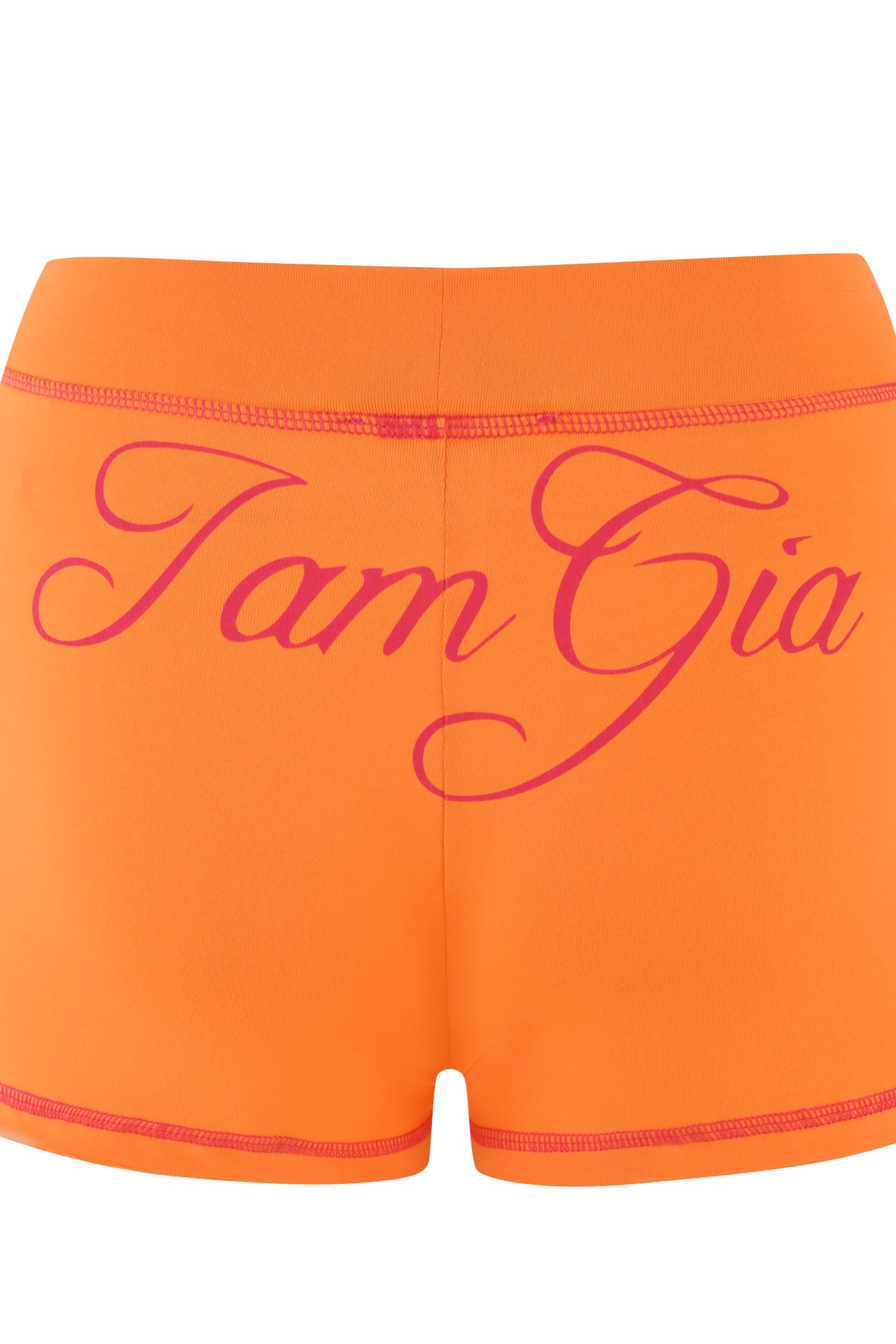 The BLARE SHORT - ORANGE by I.AM.GIA features "IamGia" elegantly scripted in pink across the back and is made from soft bamboo jersey, with a waistband and hem highlighted by subtle pink stitching.