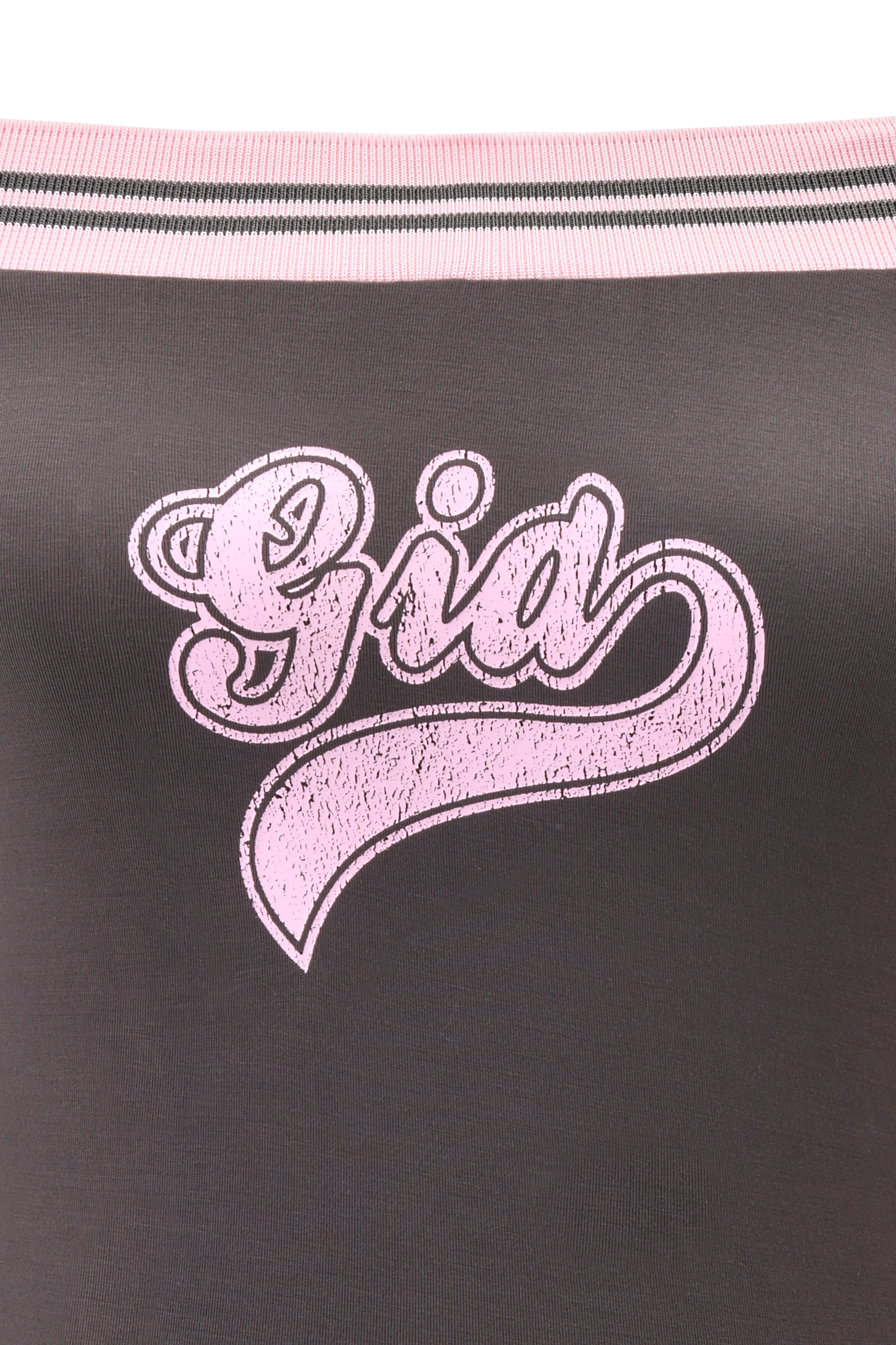 The ELLIS TOP - GREY by I.AM.GIA is a charcoal grey off-shoulder bamboo jersey top with light pink and white striped trim, featuring a bold distressed pink GIA collegiate logo across the chest.