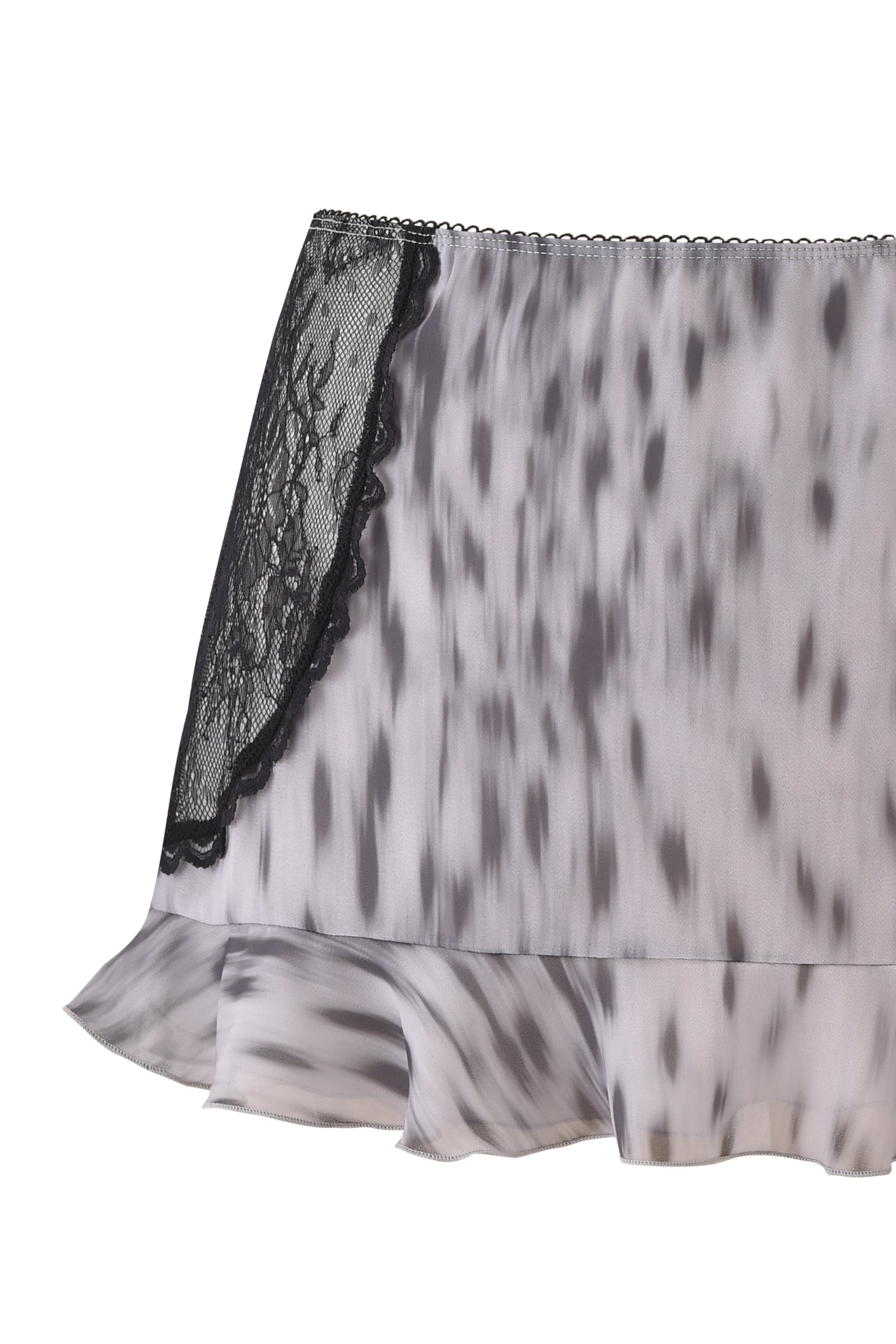 The COLETTE LACE PANEL MINI SKIRT by I.AM.GIA is a silky, light grey leopard print mini skirt with black spots, featuring a black lace trim on the left and a ruffled hem.