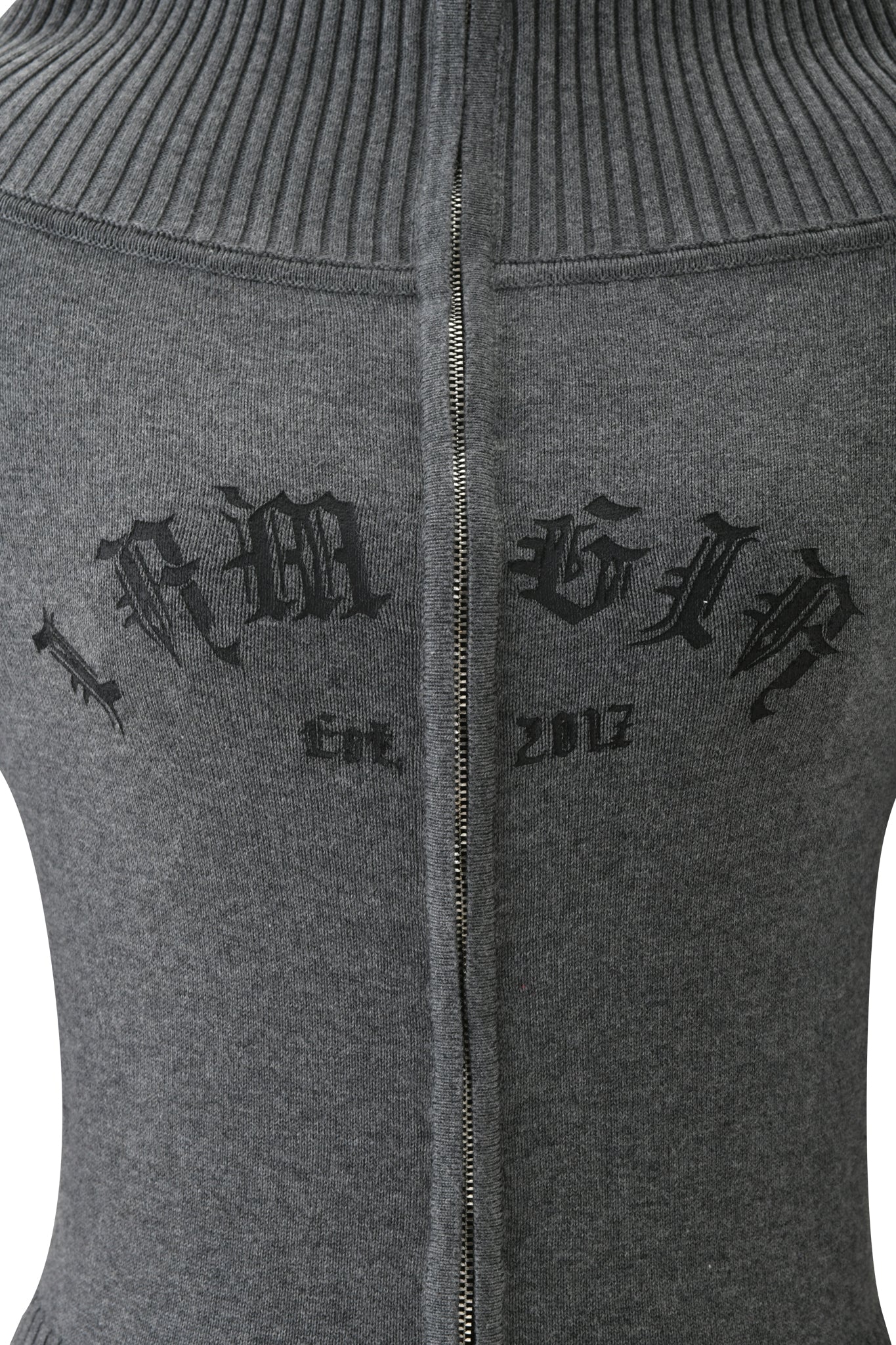 A close-up of the back of the ZION CARDIGAN - GREY by I.AM.GIA, showing a visible zipper and black Gothic text that reads "IAMGIA" above "Est. 2017".