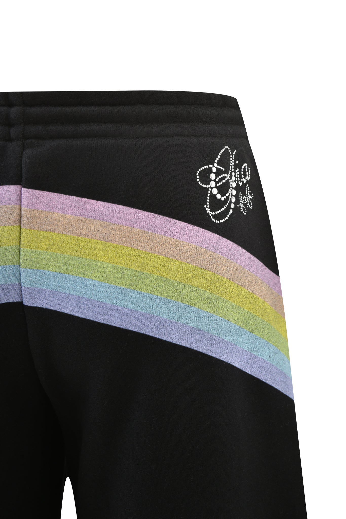 Close-up of I.AM.GIA's FAFI TRACKPANT in black, featuring a baggy, low-rise fit, diagonal pastel rainbow artwork, and a white bejeweled "Chic" logo with stars on the upper hip.