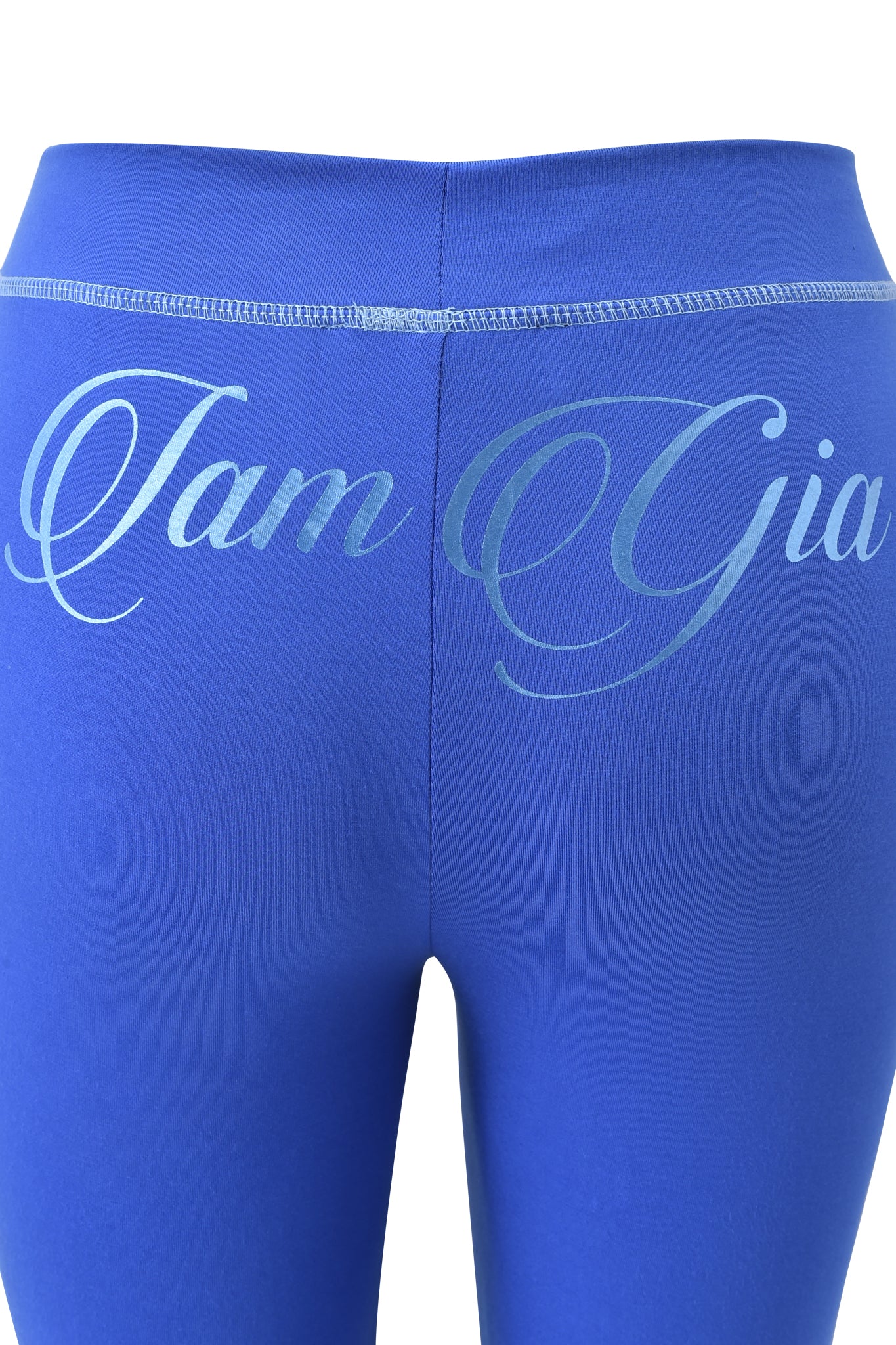 Close-up of the BLARE FORM POCKET TRACKPANT - COBALT FOIL by I.AM.GIA, featuring bright blue sculpted fabric and "I.AM.GIA" in light blue cursive across the waistband.