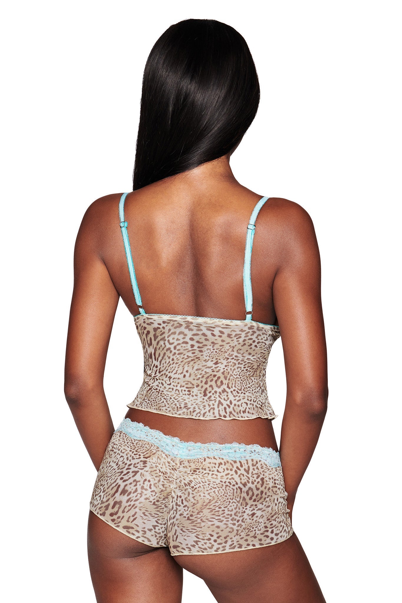 A woman with long, straight dark hair is seen from the back wearing the I.AM.GIA TASHA TOP - LEOPARD LIMBO, a leopard print mesh camisole with aqua lace trim and matching body-con boyshorts.
