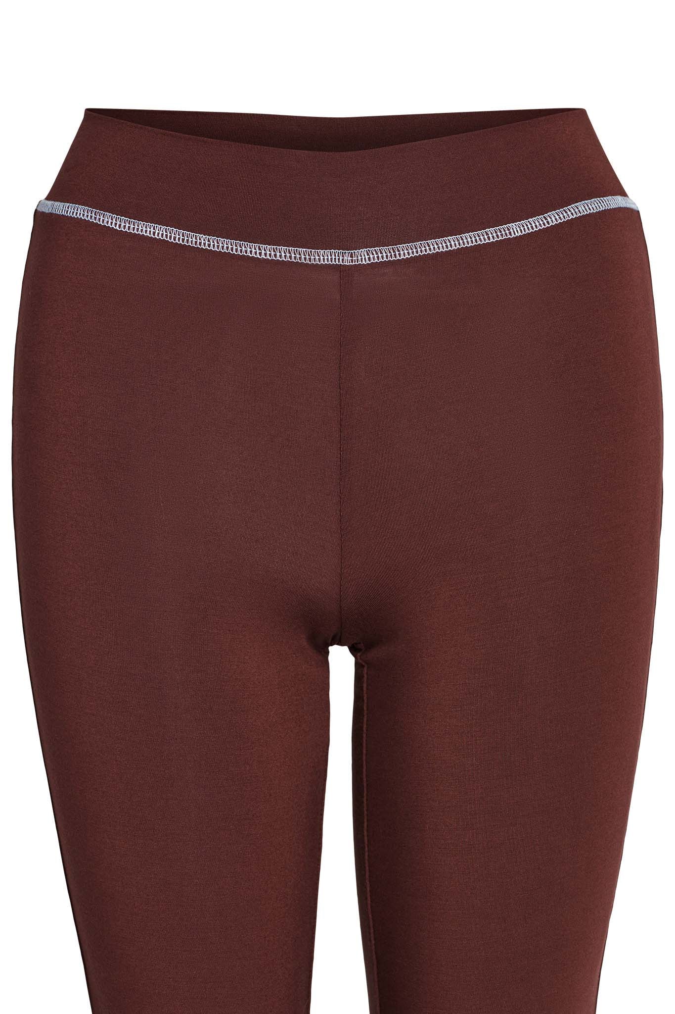 A close-up view of the BLARE TRACKPANT - BROWN from I.AM.GIA. These form-fitting athletic leggings feature a grey elastic waistband and are made from smooth, stretchy fabric.