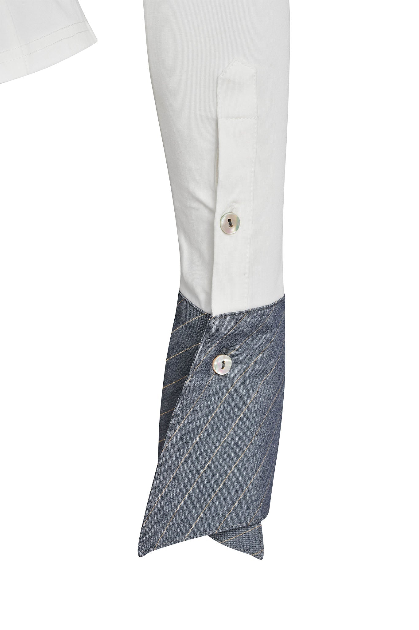 Close-up image of the SHARAH TOP - WHITE sleeve featuring a unique design. The cuff, marked with I.AM.GIA's signature style, is made of blue pinstriped fabric, fastened with a button, and extends to contrasting white fabric that spans up to the elbow with another button on a small folded flap.